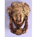 A MID 19TH CENTURY PAINTED CAST IRON DOOR KNOCKER in the form of a classical Romanesque mask head.