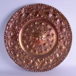AN UNUSUAL LARGE SOUTH AMERICAN COPPER AZTEC CHARGER decorated with motifs and mask heads. 61 cm
