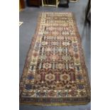 AN ANTIQUE NORTHWEST PERSIAN LONG RUG, with stylised scarab beetle border. 290 cm x 102 cm.