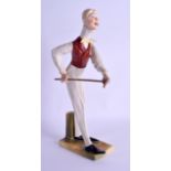 AN UNUSUAL AUSTRIAN ART DECO PORCELAIN SNOOKER PLAYER modelled upon a green & yellow painted base.