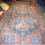 AN ANTIQUE DISTRESSED SOUMAC RUG, decorated with foliage. 395 cm x 293 cm.