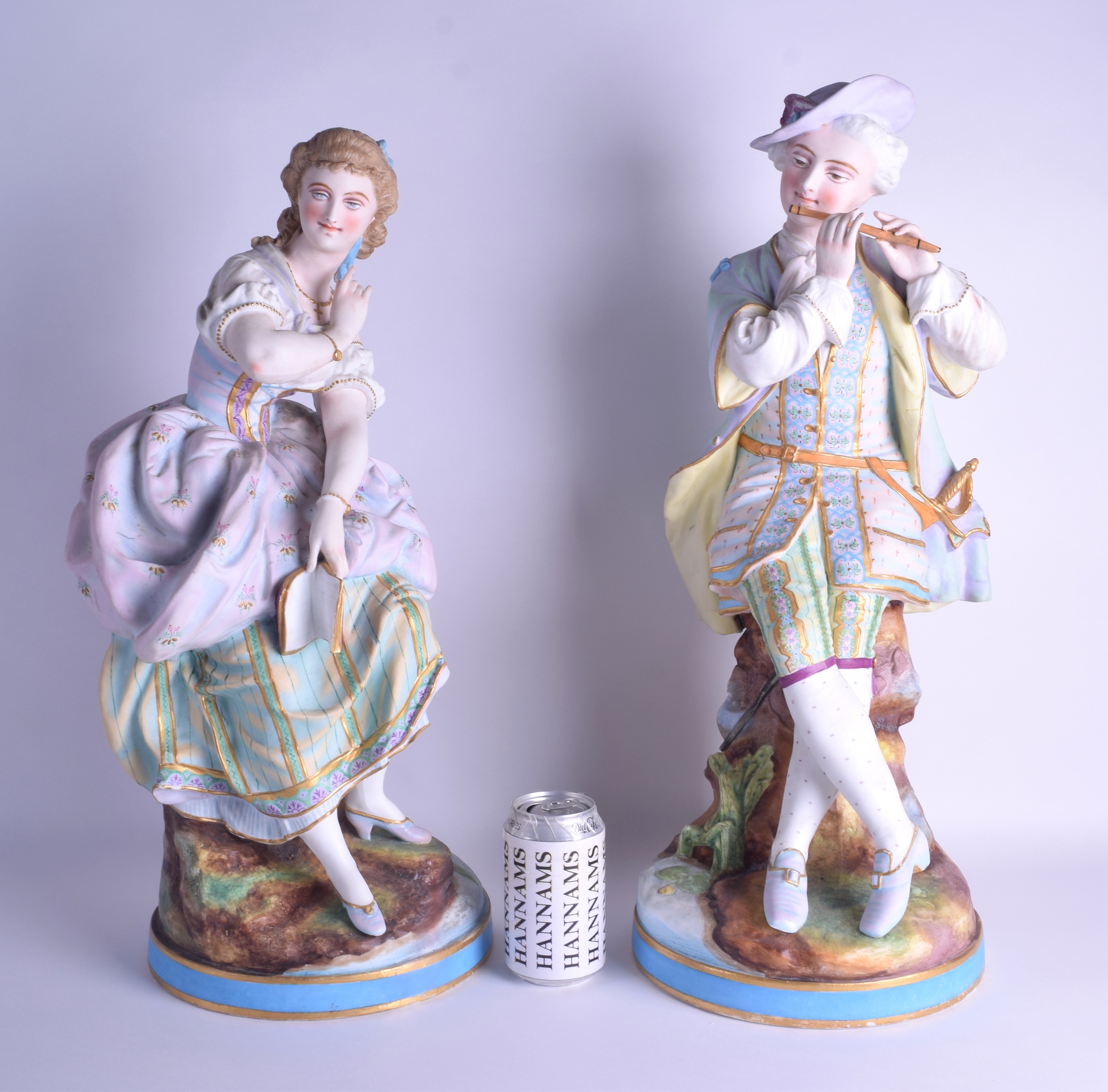 A LARGE PAIR OF 19TH CENTURY FRENCH BISQUE PORCELAIN FIGURES modelled as a male and musician and