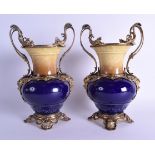 A PAIR OF 19TH CENTURY CONTINENTAL TWIN HANDLED PORCELAIN VASES of unusual two colour, with gilt