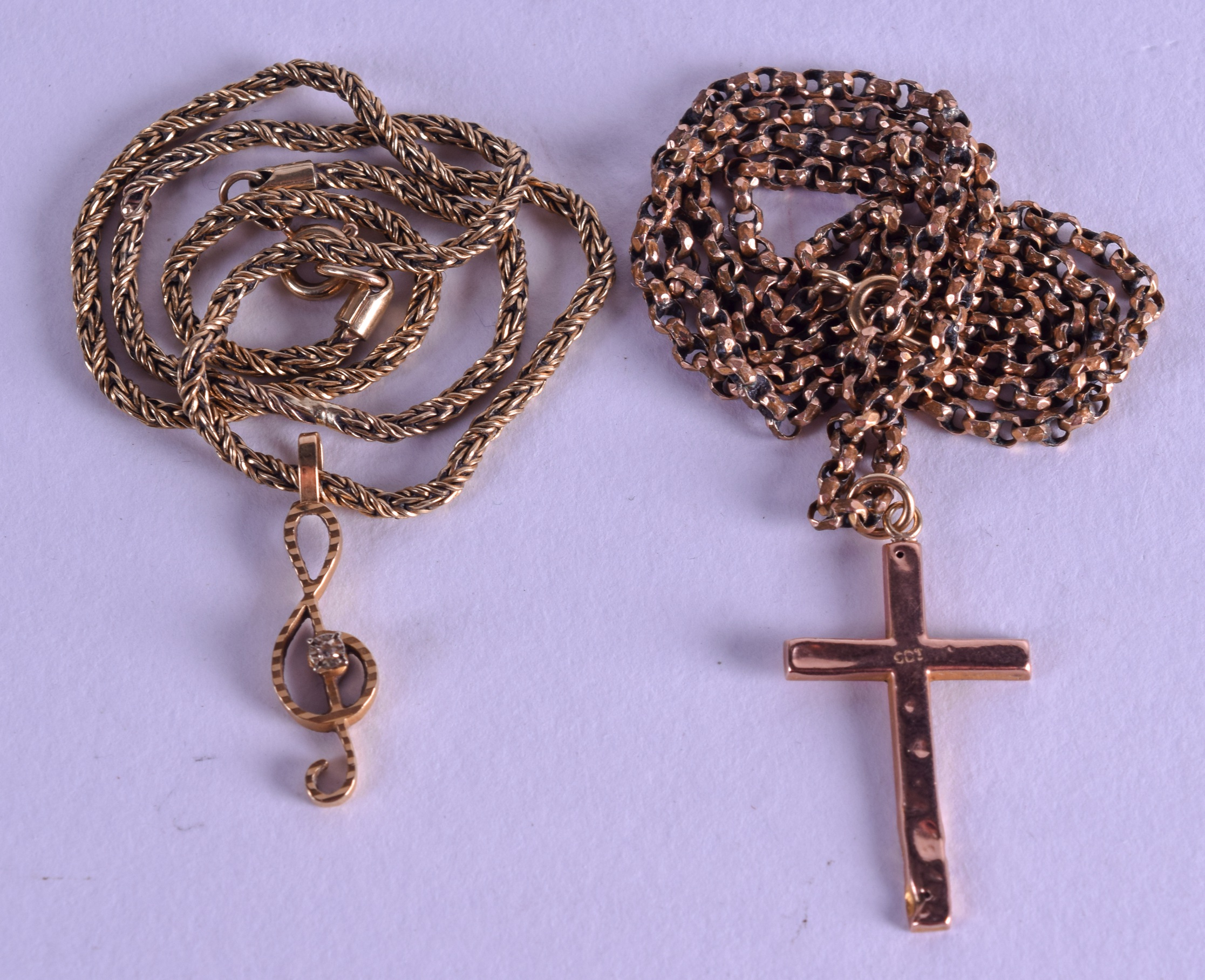A 9CT GOLD CROSS on chain, together with a 9ct gold chain with musical note pendant. 14.9 grams. (