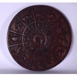 A CARVED WOODEN ZODIAC PANEL OR PLAQUE, carved with a central sun and the signs of the zodiac. 37 cm