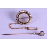 AN EDWARDIAN GOLD PEARL AND CRYSTAL LOCKET together with a tie pin. (2)