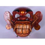 A BALINESE CARVED WOODEN CULULUK WITCH DANCE MONKEY MASK, formed with moveable jaw. 30 cm wide.