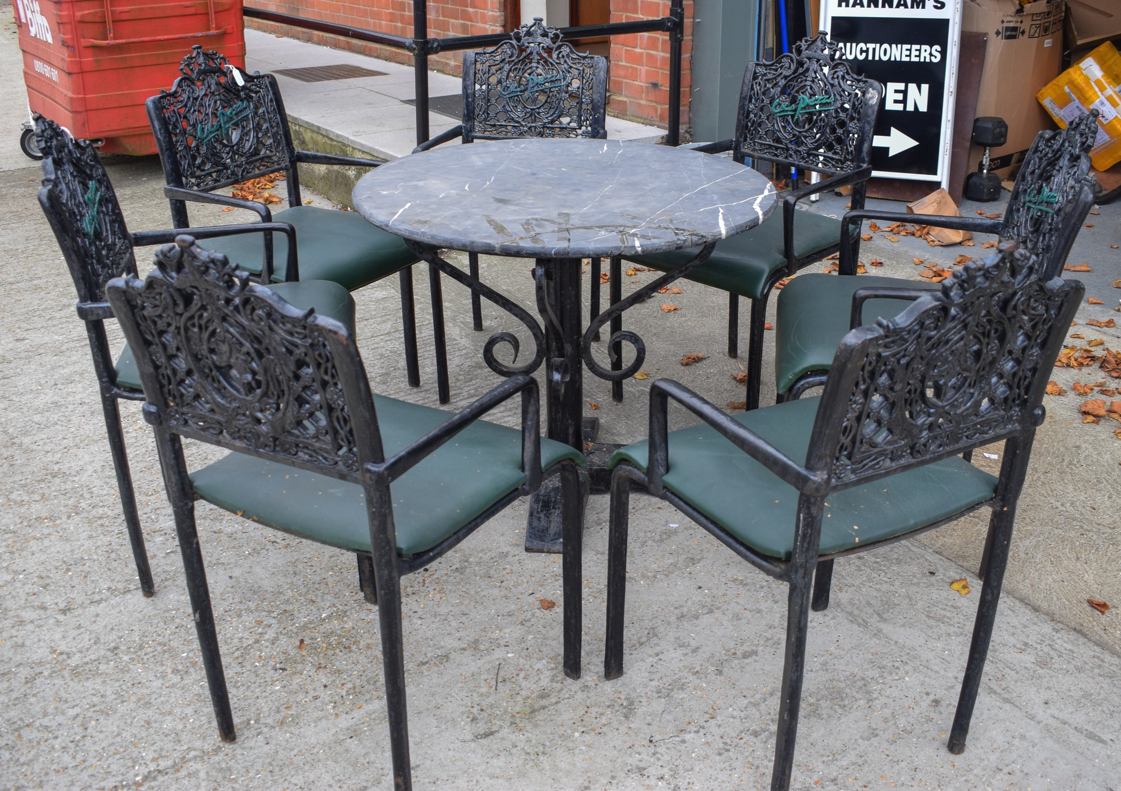 GOOD WROUGHT IRON TABLE WITH MARBLE TOP, together with seven iron chairs, the backsplats with bold