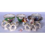 A GROUP OF GERMAN PORCELAIN FLORAL ENCRUSTED NAPKIN RINGS, together with two apple green ground