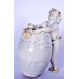 A PALE GLAZED PORCELAIN FIGURAL BARREL OF A GROTESQUE MALE MOUNTING A KEG, covering his modesty with