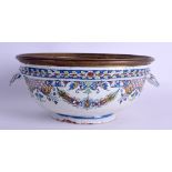 AN 18TH CENTURY FRENCH ROUEN TIN GLAZED EARTHENWARE BOWL with metal rim, painted with flowers. 25 cm