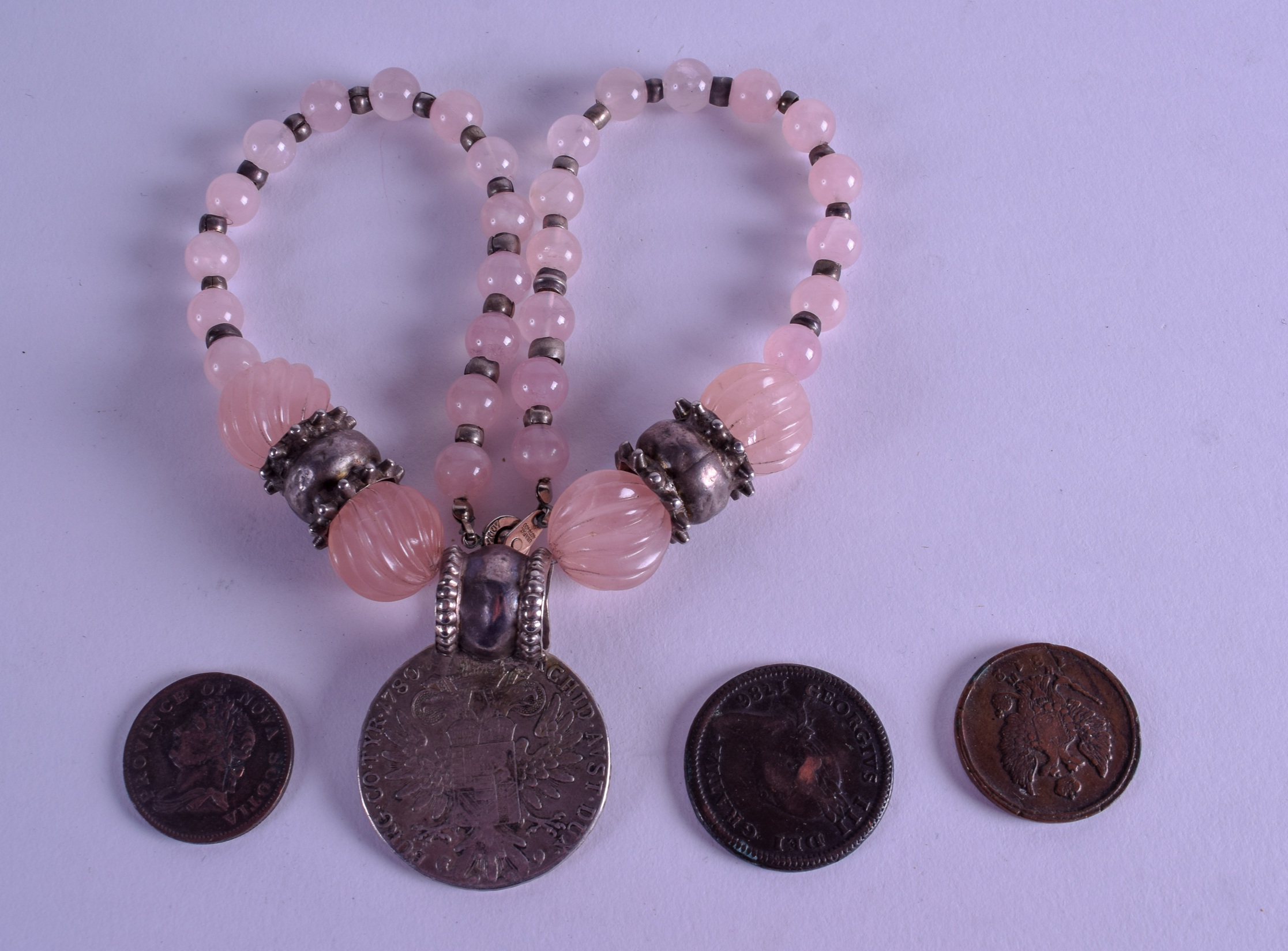 AN UNUSUAL ISLE OF MAN COIN together with two other coins & a 1780 Theresiad necklace. (4)