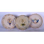 A SET OF THREE EARLY 20TH CENTURY FAIENCE POTTERY PLATES, decorated with crest type decoration. 25