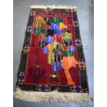 A 20TH CENTURY RUG DEPICTING AFGHANISTAN. 150 cm x 85 cm.