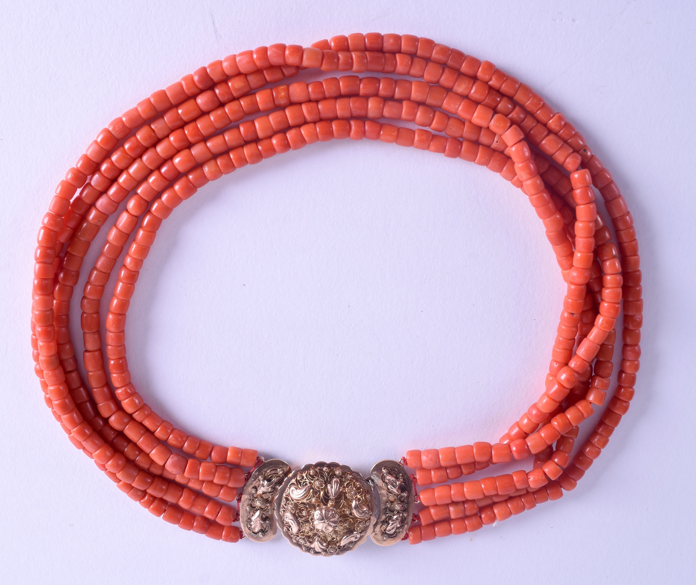 AN 18CT GOLD MOUNTED CORAL NECKLACE. 110 grams. Each strand 80 cm long, each bead 0.3 mm wide.