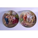 A GOOD PAIR OF VIENNA PORCELAIN DISHES painted with classical figures within landscapes. 32 cm