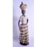 A RARE LARGE NAO FIGURE OF AN AFRICAN FEMALE modelled with a basket of fruit upon her head. 50 cm
