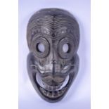 AN ANTIQUE CARVED TRIBAL MASK, with boldly carved facial features. 37 cm long.