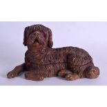 A 19TH CENTURY BAVARIAN BLACK FOREST INKWELL in the form of a recumbent dog. 22 cm x 12 cm.