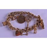 A GOLD CHARM BRACELET with attached charms. 39 grams.