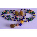AN EARLY 20TH CENTURY CARVED GLASS IMITATION CORAL AND BAKELITE NECKLACE. 90 cm long.
