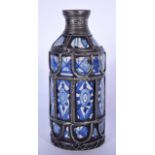 AN EARLY 20TH CENTURY IZNIK TYPE POTTERY FLASK, overlaid with white metal strap banding and