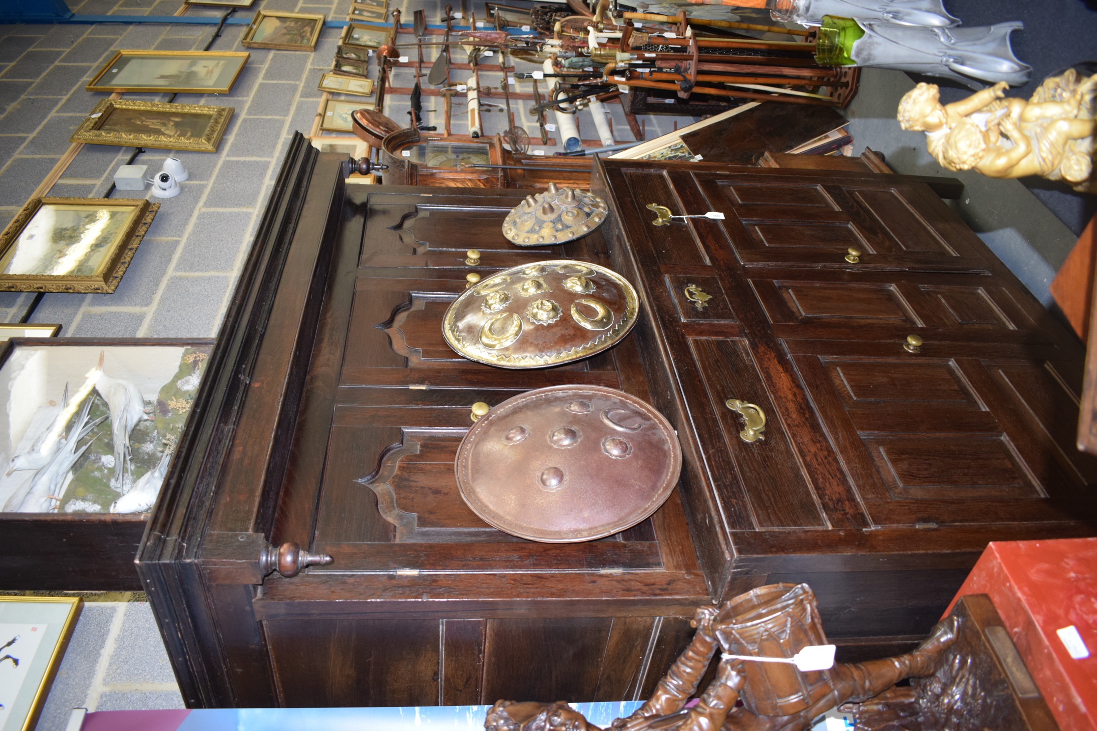 AN 18TH CENTURY OAK COURT CUPBOARD, with fitted drawers, panelled doors and swan neck brass handles.