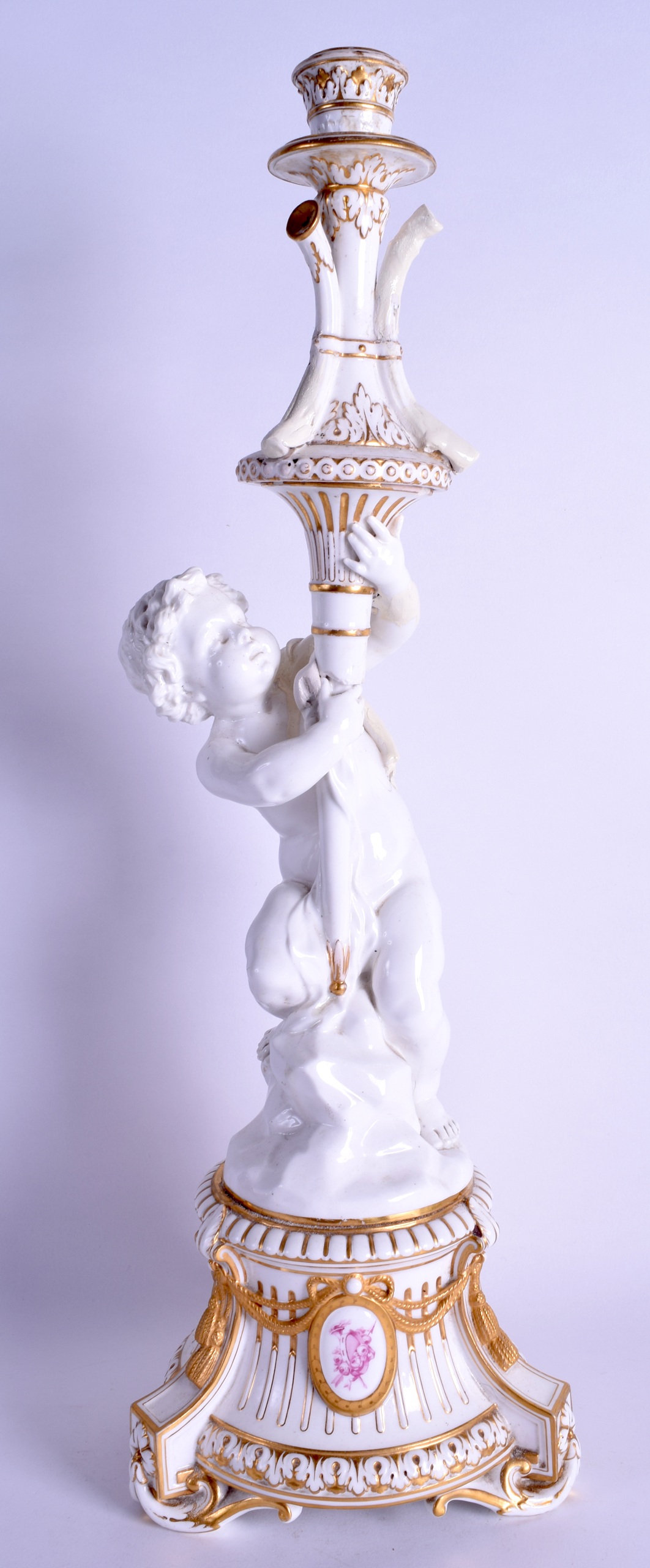 A LARGE 19TH CENTURY WHITE GLAZED PORCELAIN CANDLESTICK painted with puce arms, over scrolling