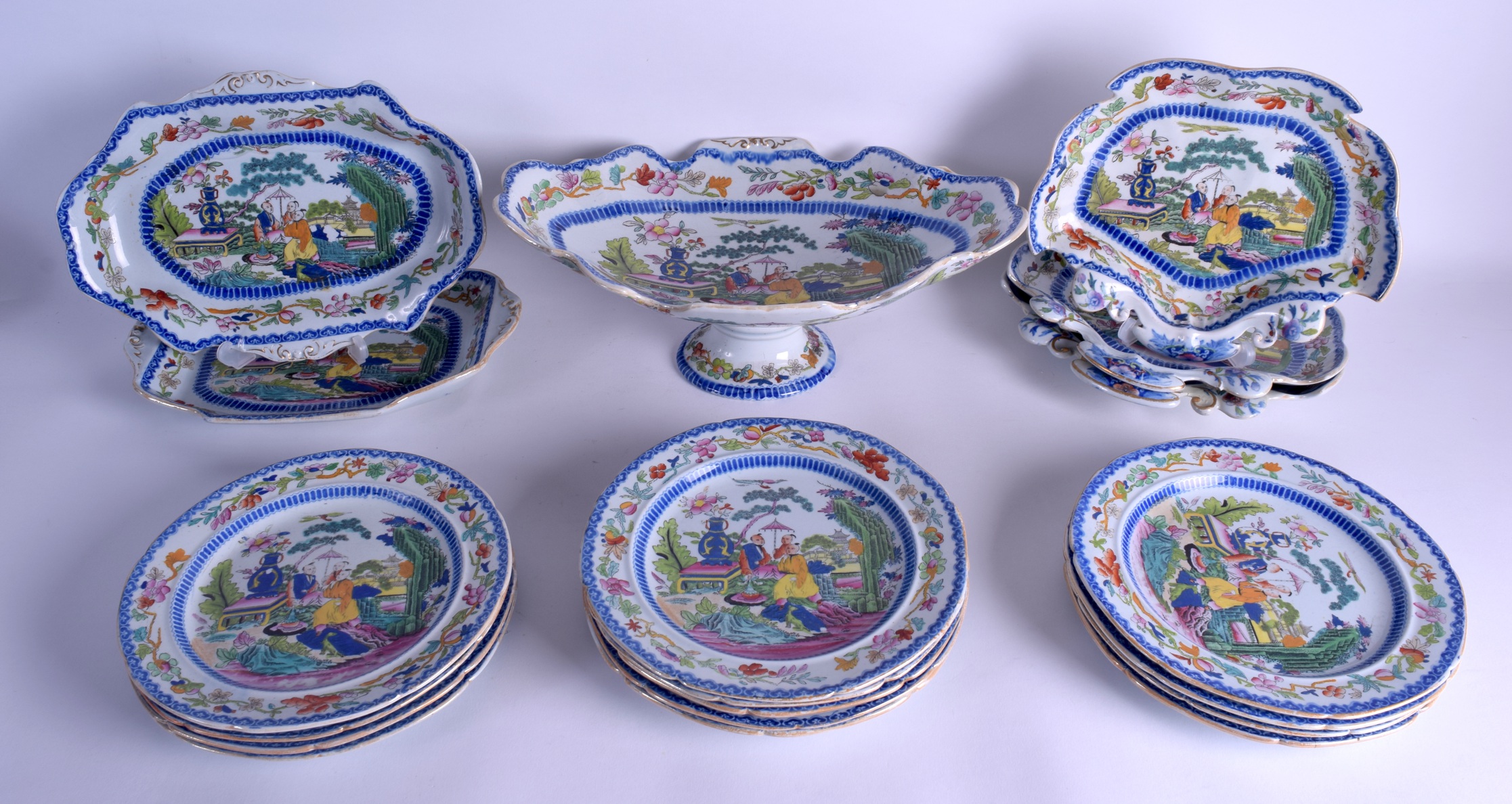 AN EARLY 19TH CENTURY MASONS IRONSTONE SERVICE decorated with Oriental figures within landscapes.
