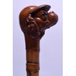 A RARE LATE VICTORIAN/EDWARDIAN CARVED FRUITWOOD WALKING CANE in the form of a jockey modelled as