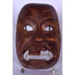 A BALINESE CARVED WOODEN BONDRES BUES TOWN BULLY MASK, formed as the rambling drunk thug. 19.5 cm