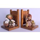 A PAIR OF GERMAN GOEBEL HUMMEL FIGURAL BOOKENDS modelled as a boy with rabbits & a girl with chicks.