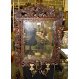 A 19TH CENTURY CONTINENTAL CARVED WOOD GIRONDOLE MIRROR decorated with foliage. 52 cm x 71 cm.