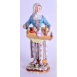 A 19TH CENTURY GERMAN SITZENDORF FIGURE OF A FEMALE modelled holding a baby within a crib. 16.5 cm