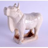 A 19TH CENTURY INDIAN POTTERY FIGURE OF A COW. 12 cm x 12 cm.