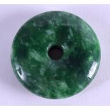 A CHINESE CARVED JADEITE TOGGLE. 4.75 cm diameter.