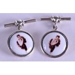 A PAIR OF EROTIC SILVER CUFFLINKS.