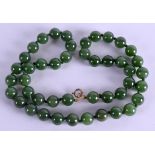 A CHINESE CARVED JADE NECKLACE. 52 cm long.