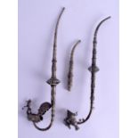 TWO EARLY 20TH CENTURY SOUTH EAST ASIAN WHITE METAL PIPES one with a terminal in the form of a bird,