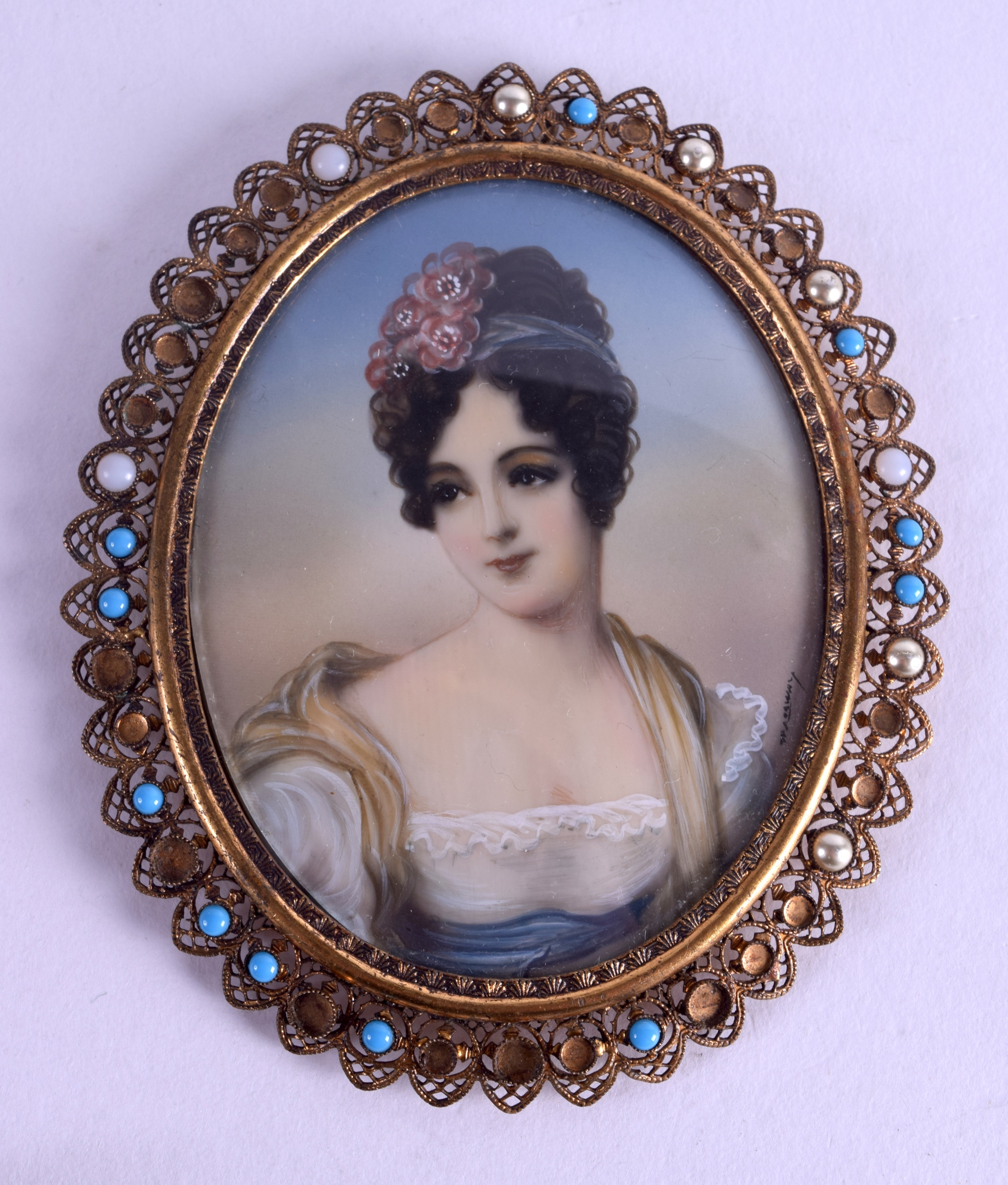 AN EARLY 20TH CENTURY CONTINENTAL PAINTED IVORY PORTRAIT MINIATURE within a jewelled frame. Image