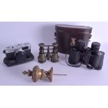 AN OLYMPUS CAMERA together with two binoculars and a bronze finial. (4)