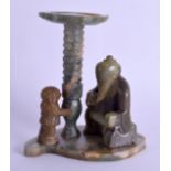 AN UNUSUAL EARLY 20TH CENTURY CHINESE CARVED MUTTON JADE STAND modelled as a seated scholar beside a