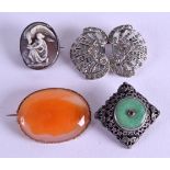 AN EARLY 20TH CENTURY SILVER JADE AND RUBY BROOCH together with three others. (4)