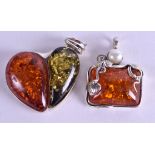 TWO SILVER AND AMBER PENDANTS. (2)