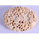 A 19TH CENTURY CHINESE CARVED IVORY BROOCH Qing, decorated with flowers. 6 cm x 4.5 cm.