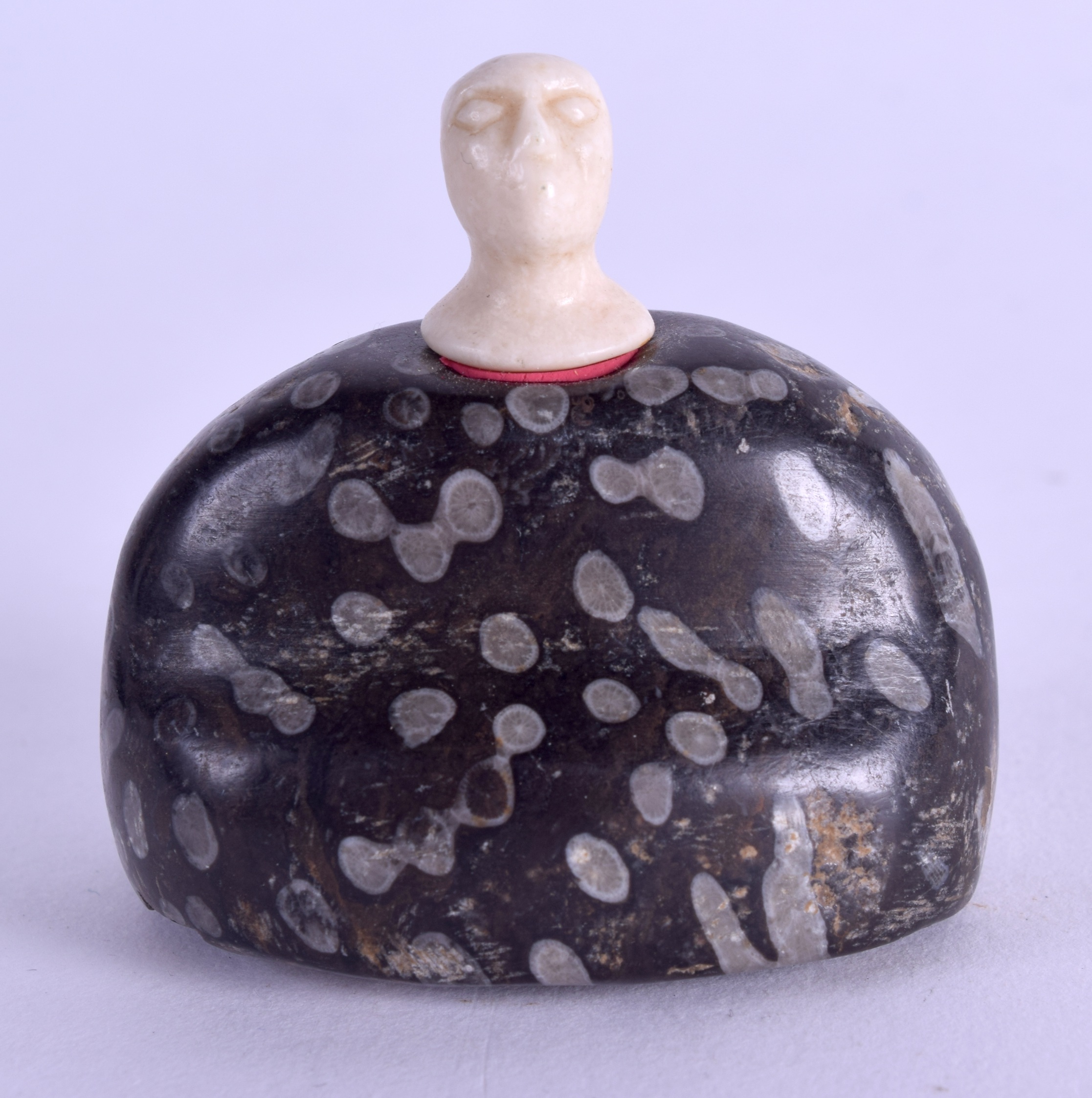 AN UNUSUAL CARVED STONE IDOL. 5.5 cm wide.