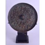 A MIDDLE EASTERN CENTRAL ASIAN BRONZE MIRROR decorated with animals and foliage. 13 cm diameter.