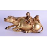 A CHINESE TIBETAN GILT BRONZE FIGURE OF A RECUMBANT RAM modelled with two kids upon his back. 17.5