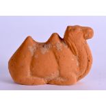 AN EARLY POTTERY CAMEL modelled recumbant. 8.25 cm wide.