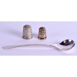 A 1960S ENGLISH SILVER HAMMERED SPOON together with two silver thimbles. (3)